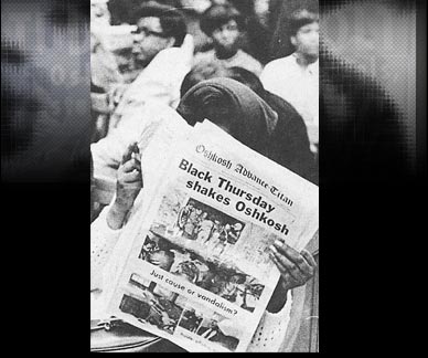 Woman Reading newspaper about Black Thrusday in Oshkosh